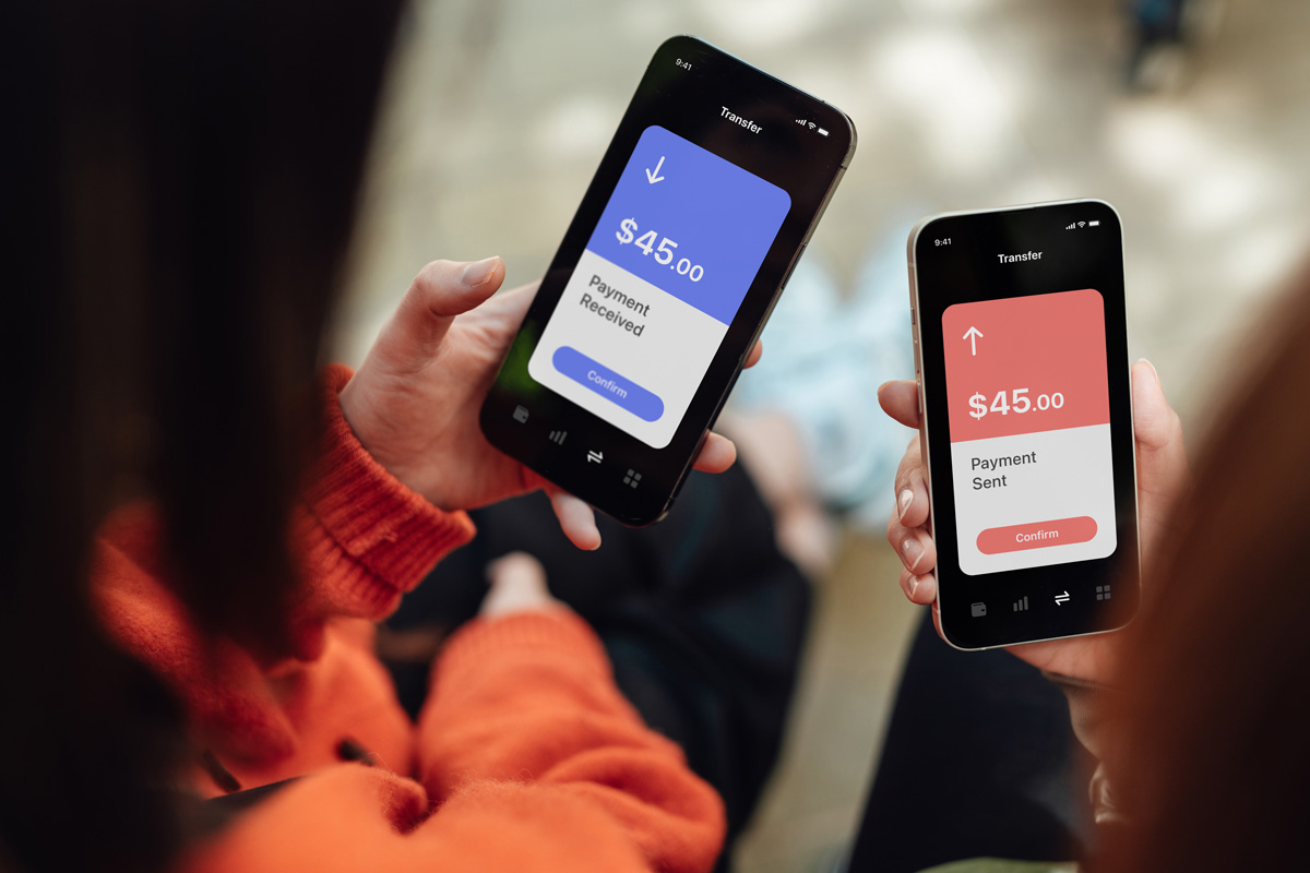 dos personas transfiriendo dinero entre sus teléfonos