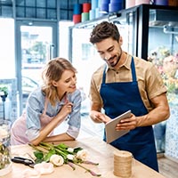 florists with digital tablet in flower shop