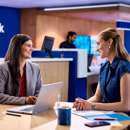 A young woman entrepreneur is getting help from a banker at a U.S. Bank branch.
