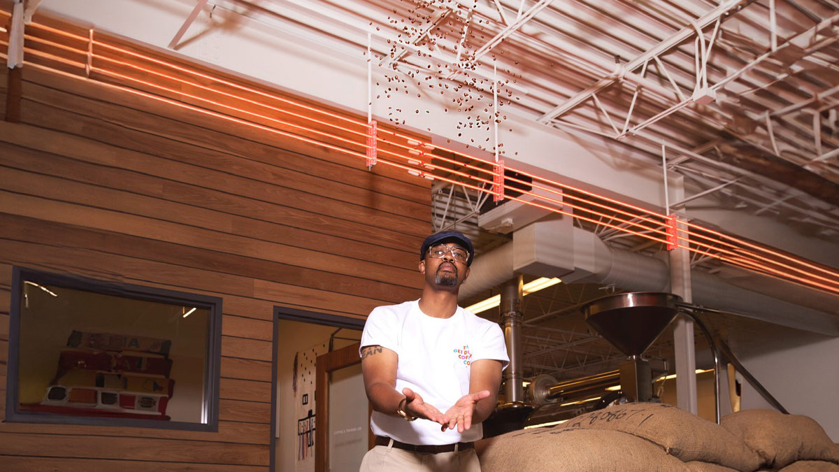 Man throwing coffee beans in the air