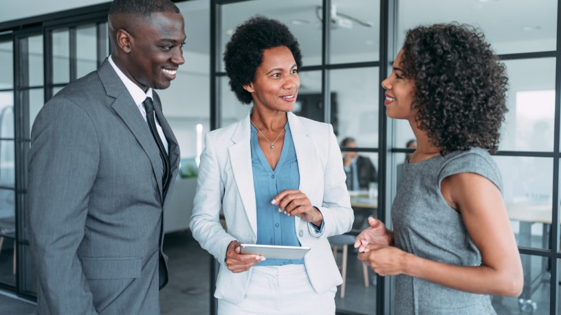 three-business-people-outside-conference-room