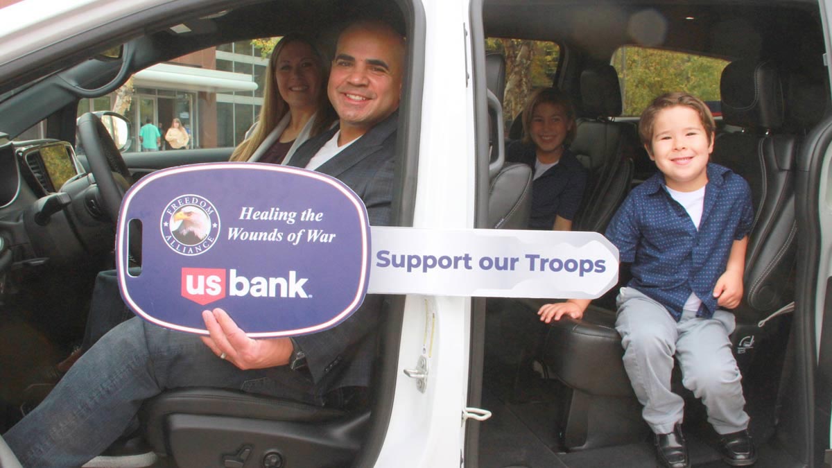 Veteran and his family in a new car