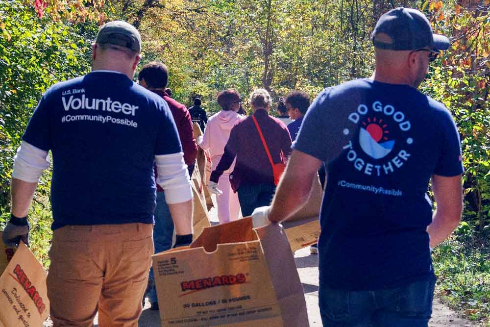 Volunteers cleaning in a park. 