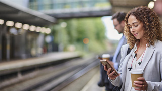 woman commuting looking at her phone