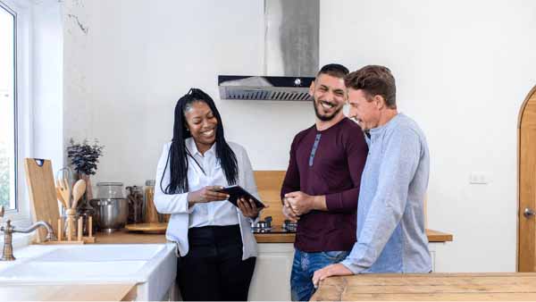 Couple in kitchen discussing how credit score affects home purchases