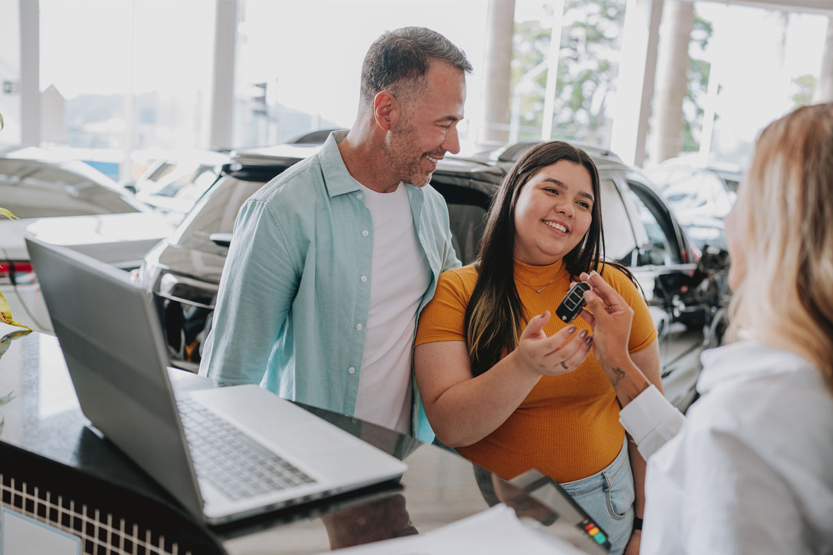 dad and daughter buying a car