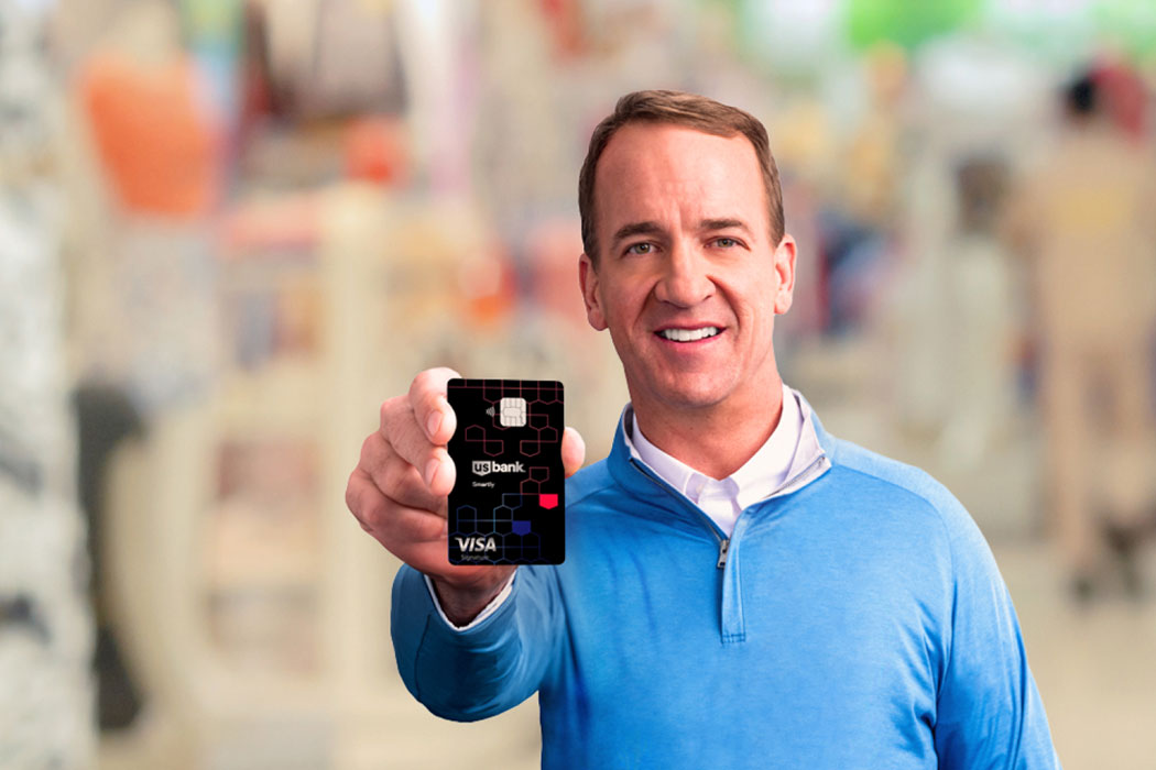 Payton Manning holding the U.S. Bank Smartly Visa Signature Card