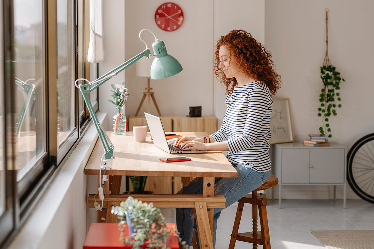 woman working at her home office desk