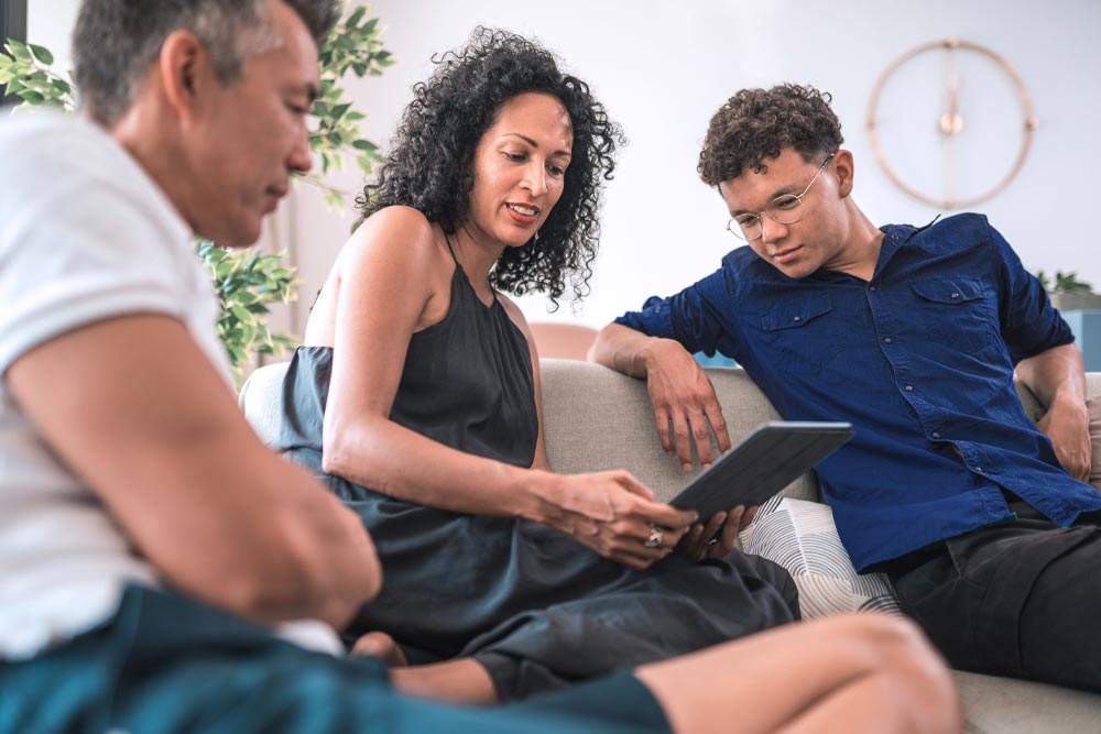 Man and woman having conversation with adult son