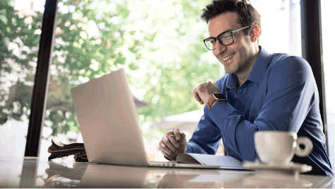 Man smiling working on a computer