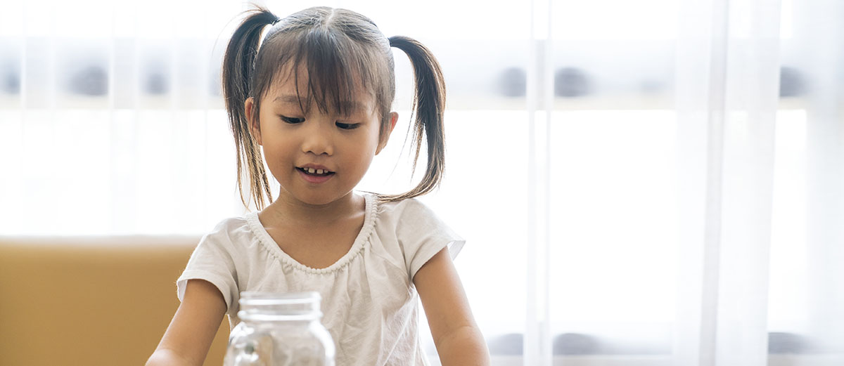 Minor child learning to count money