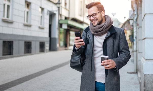 Man walking using mobile phone