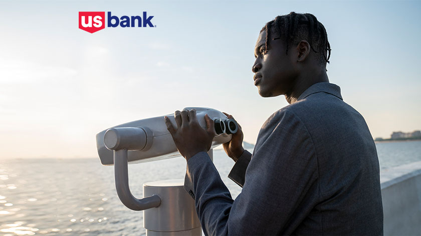 Thoughtful man looking over ocean U.S. Bank logo