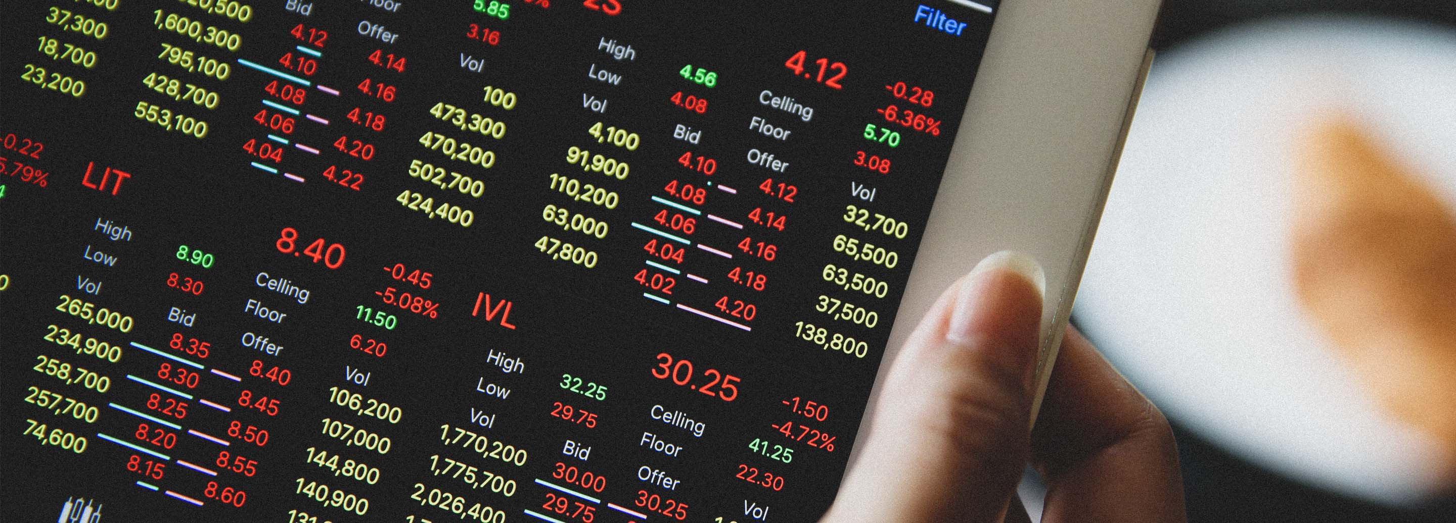 person reviewing stock market on iPad