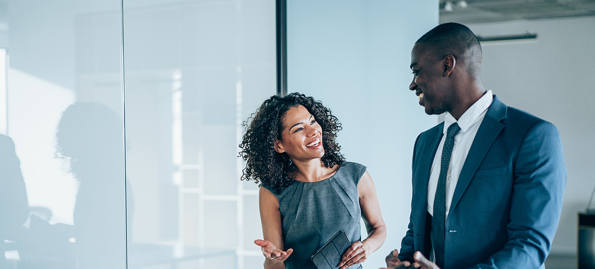 Man and woman speaking to each other in an office