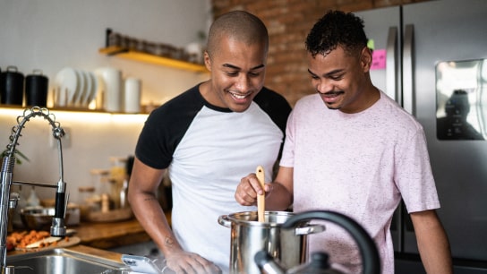 Two men cooking in a kitchen.