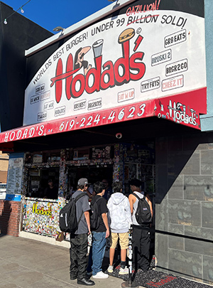 The exterior of Hodad's with a small line of people at the door.