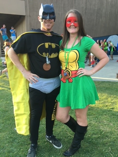 Man and woman in superhero costumes