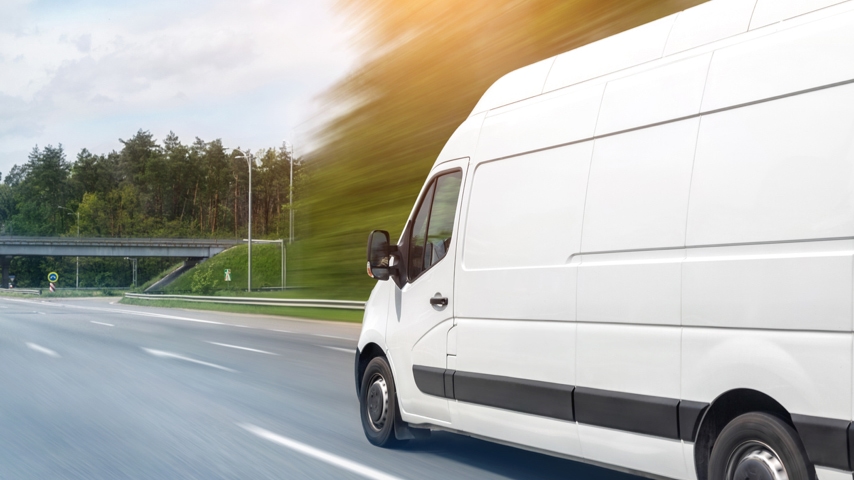 white fleet van driving on road