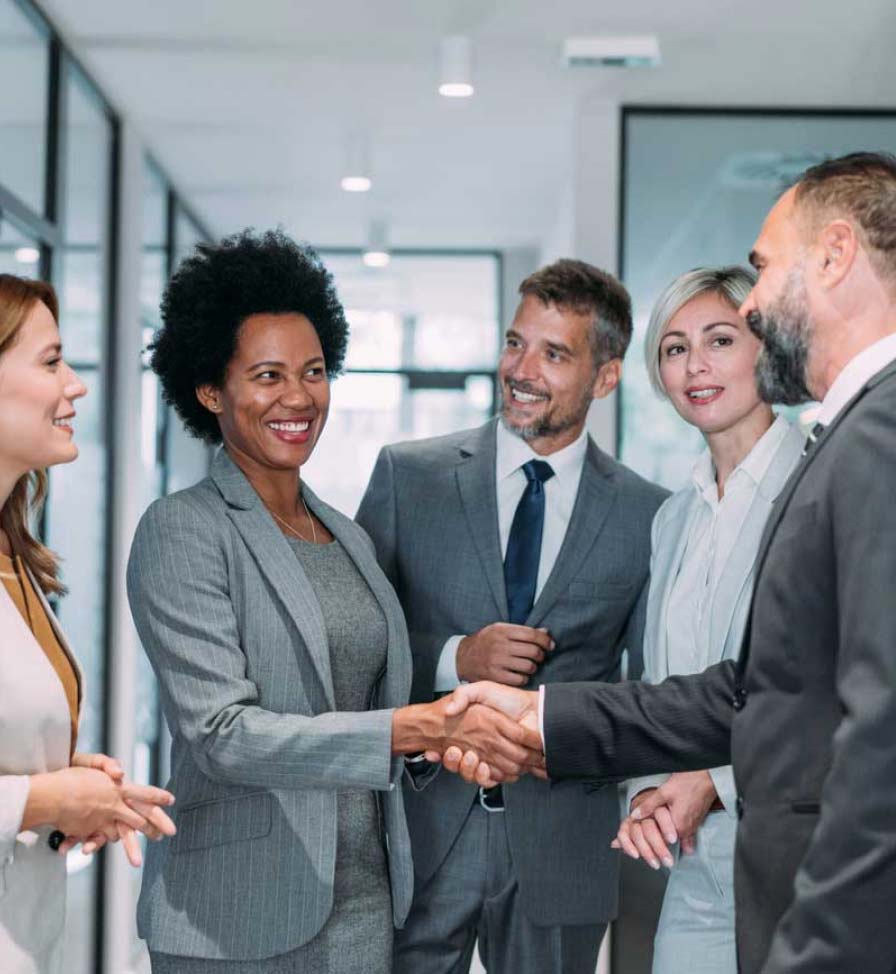 Group of business colleagues greeting each other in an office